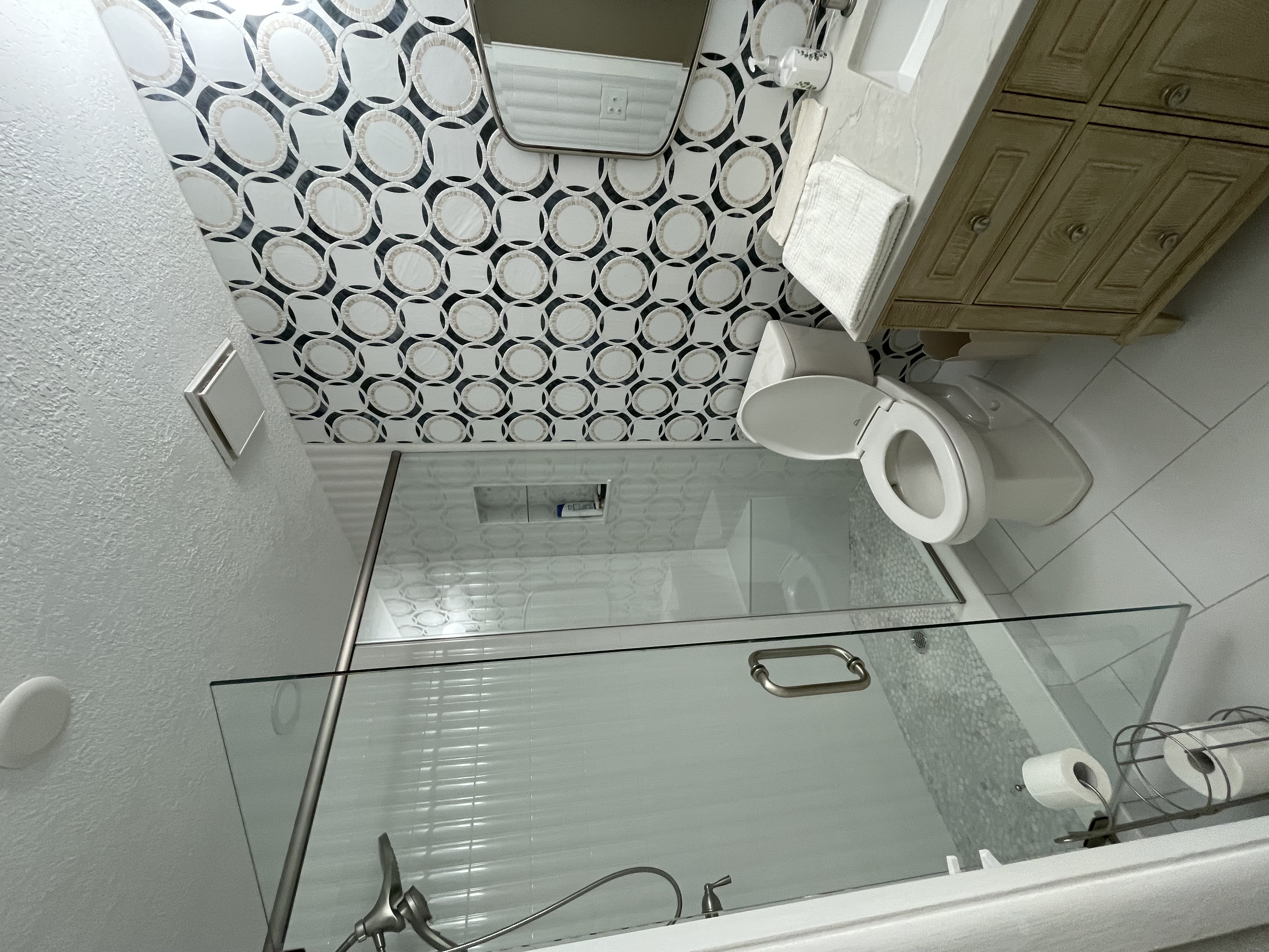 Master bathroom remodel with circular mosaic accent wall and glass shower, Largo FL
