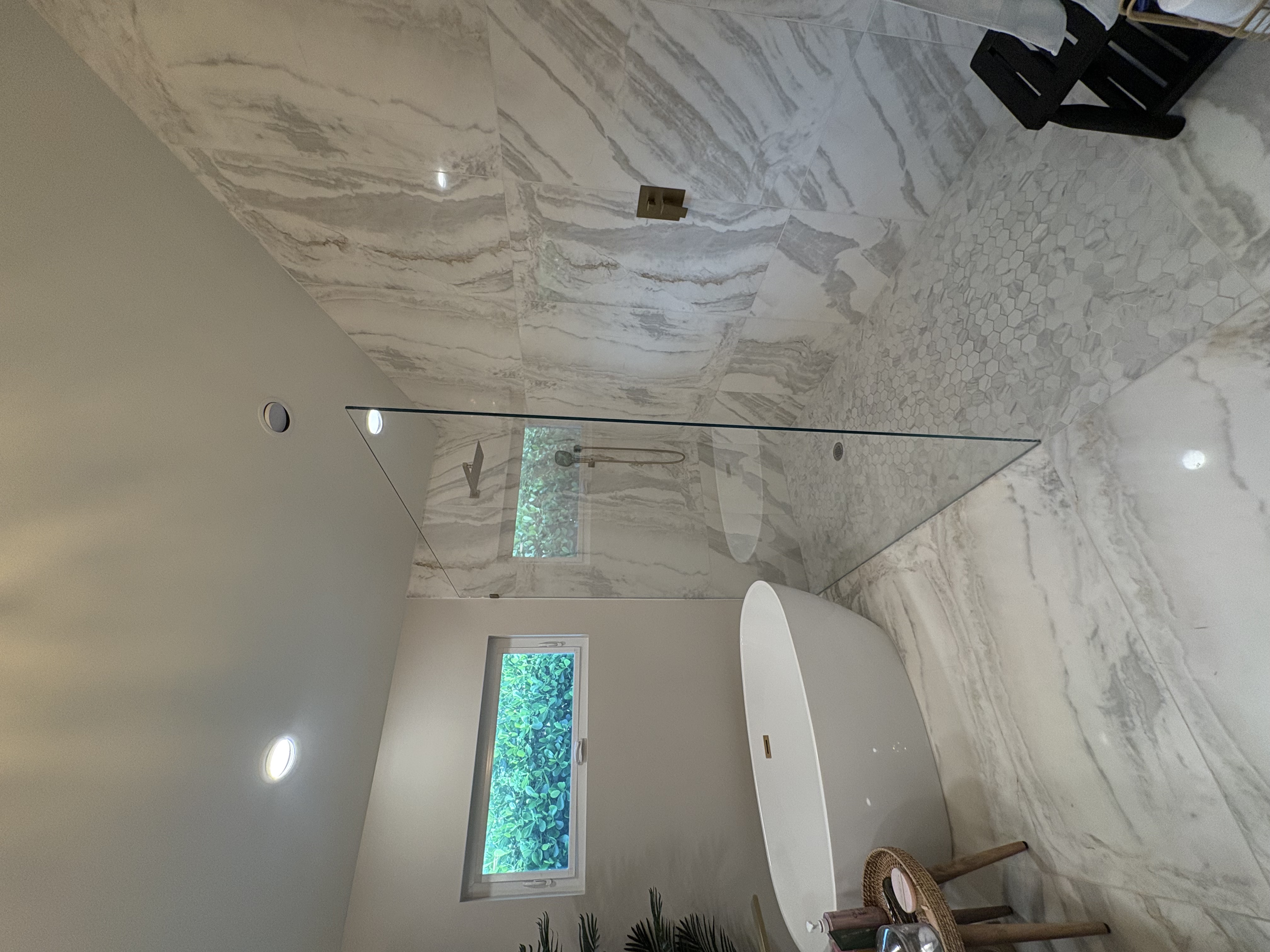 Marble spa bathroom with book-matched marble walls and hexagon floor, Tampa Bay FL