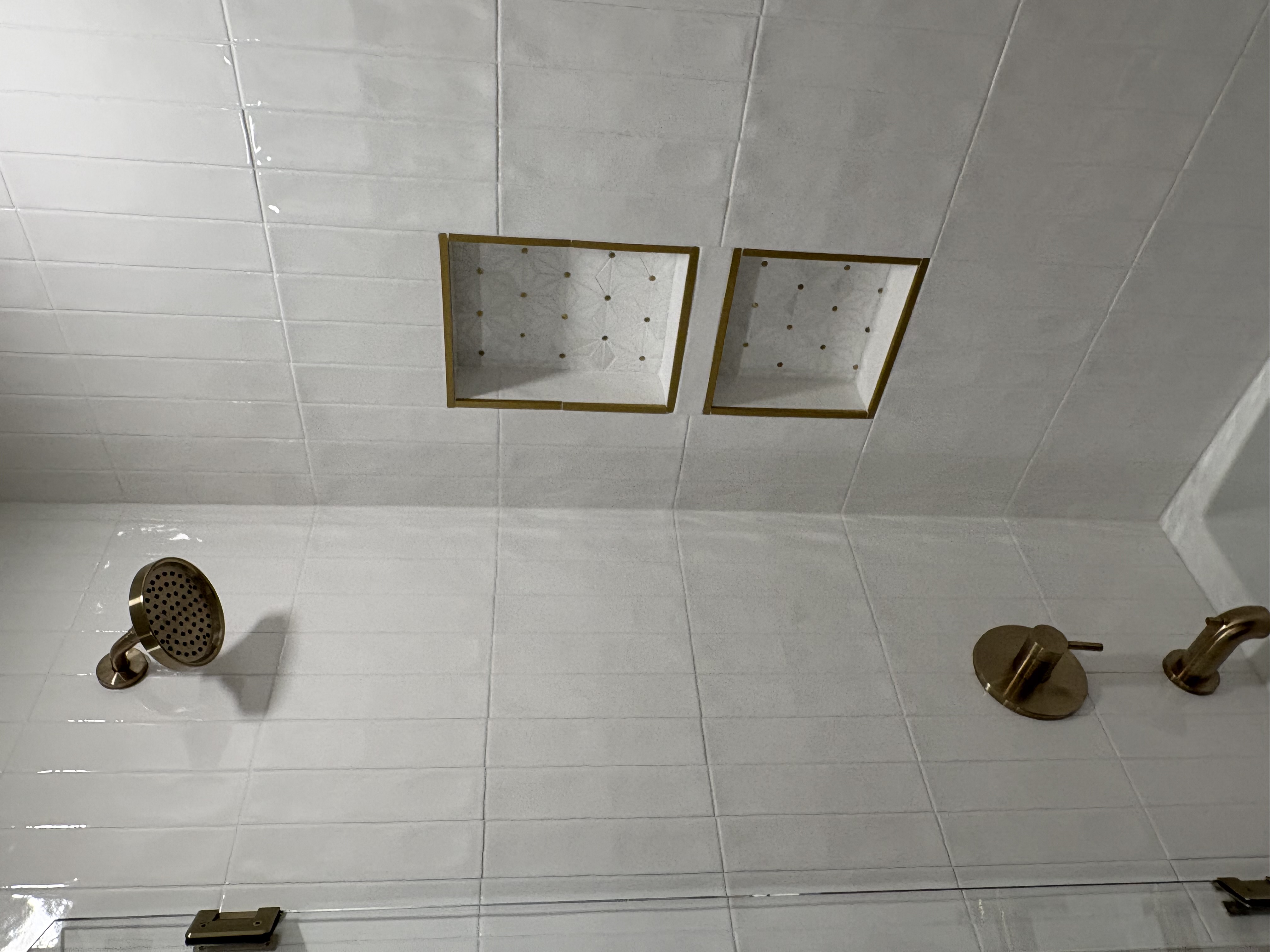 White subway tile shower with brass fixtures and gold-trim niches, Largo FL
